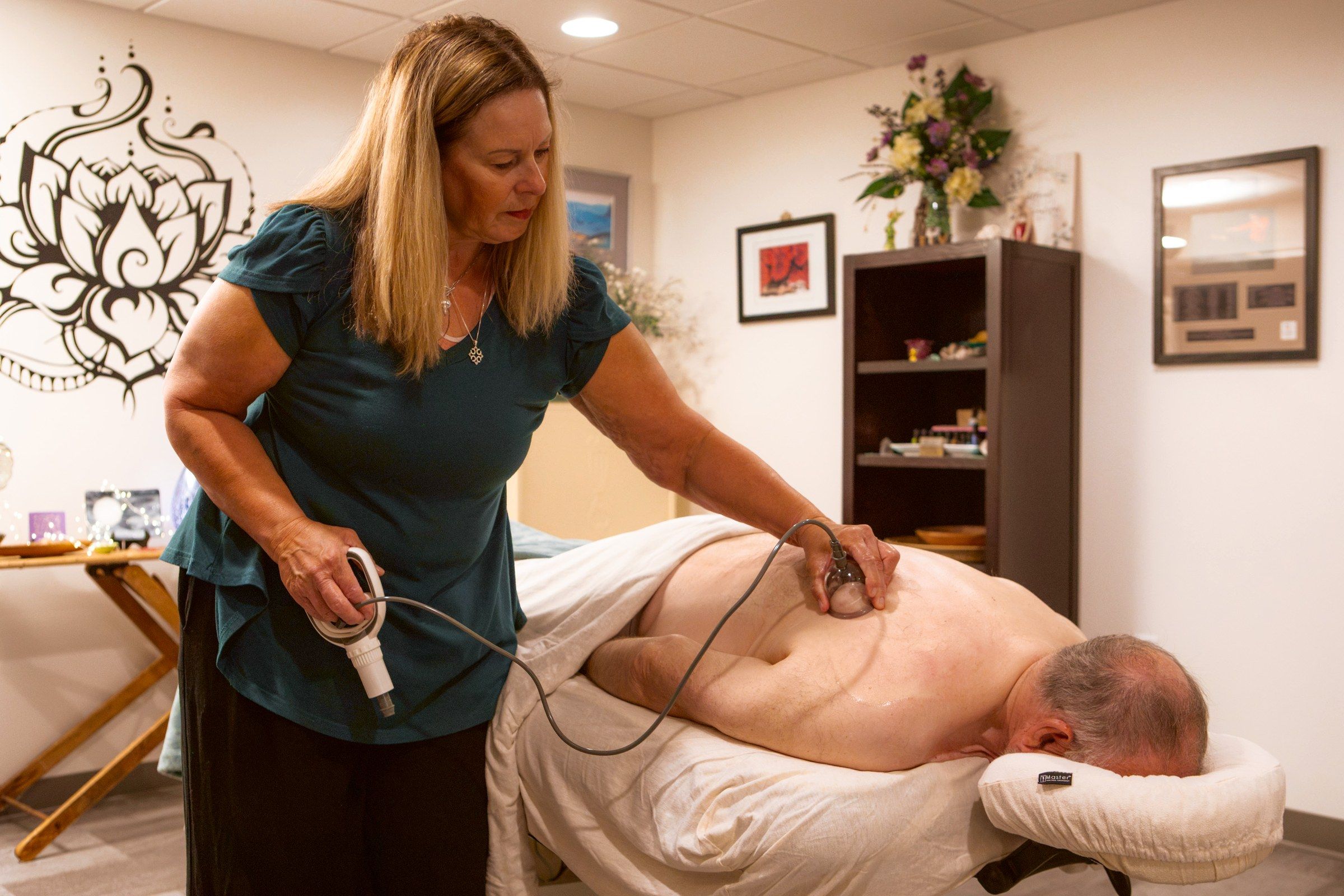 Melissa cupping a client in the lotus room