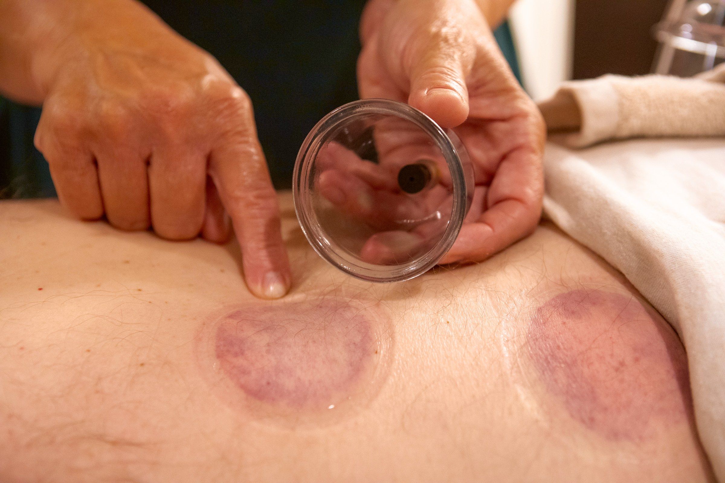 Melissa lifting a cup, the round mark it leaves beneath