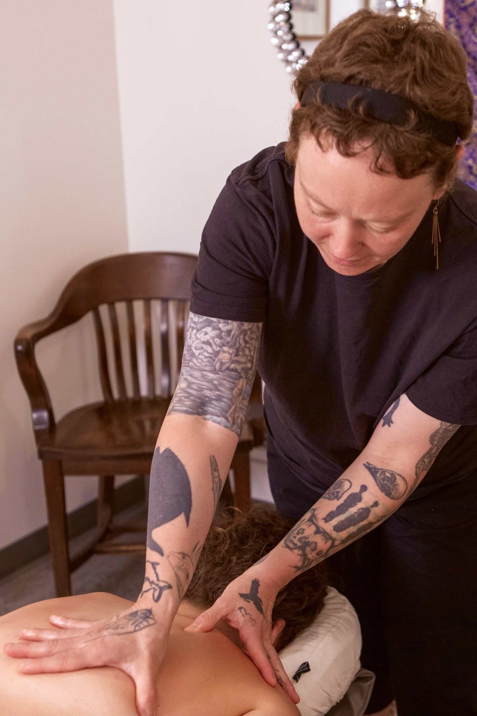 Nicole working a client's back