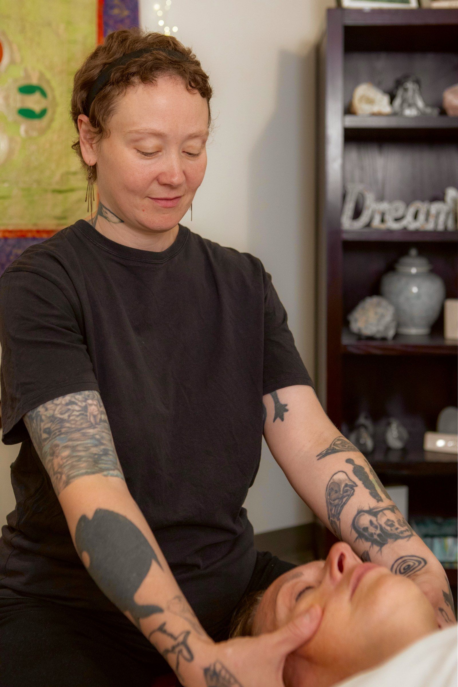 Nicole cradling a client's head, face up
