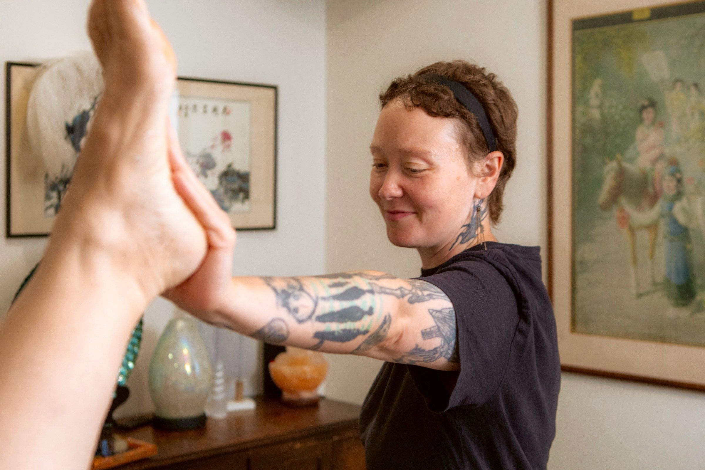 Nicole stretching a client's leg