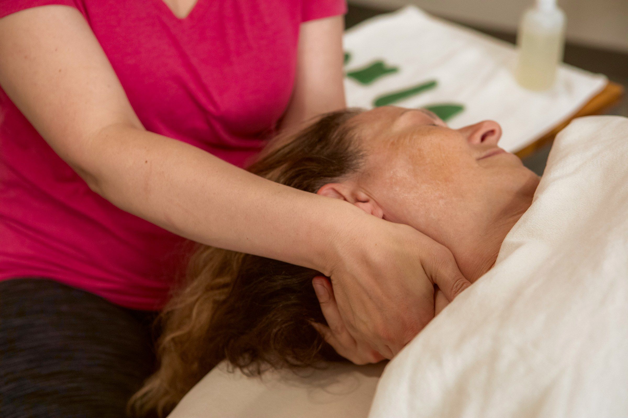 Krissy working a client's neck and shoulders