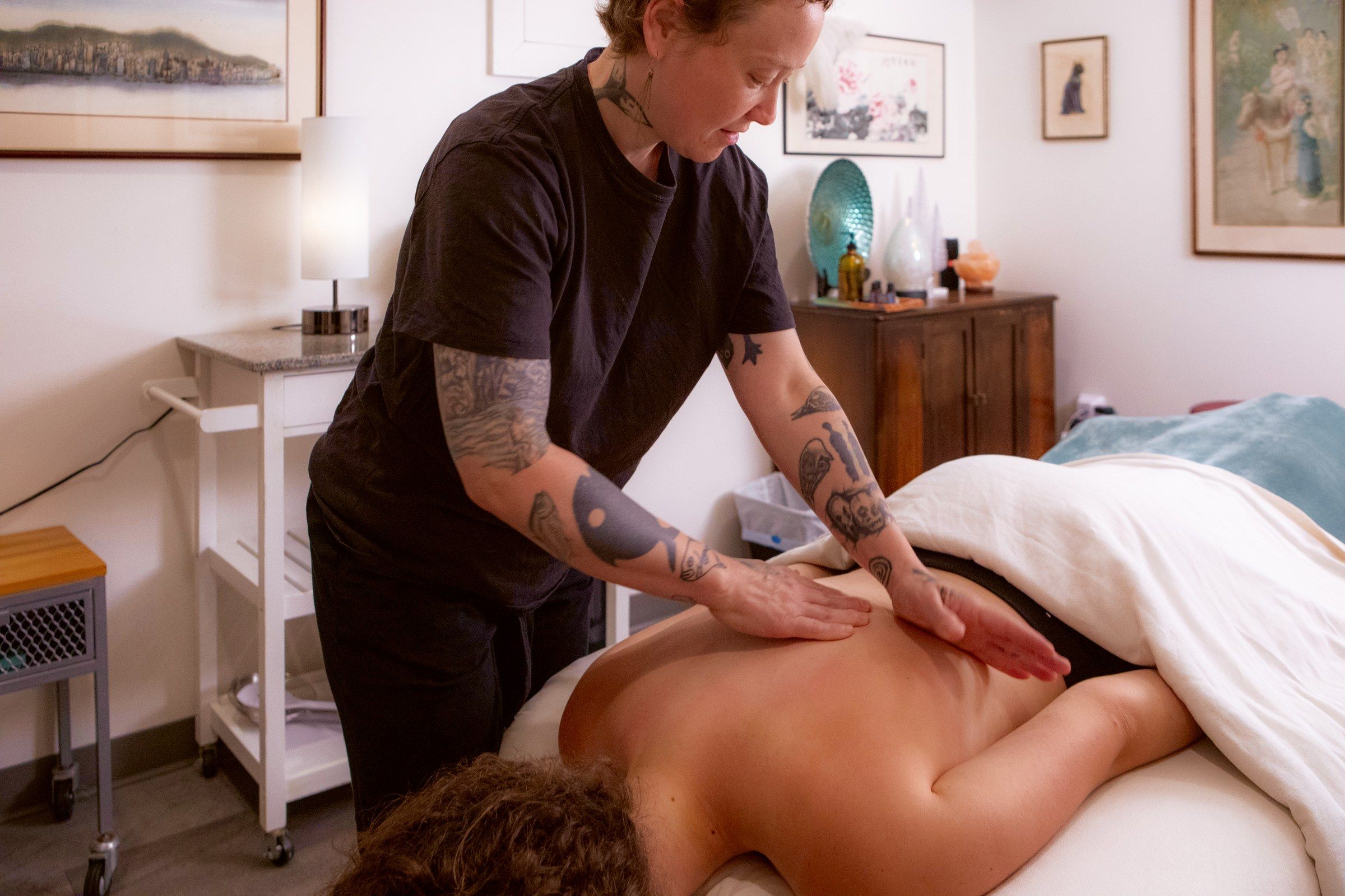 Nicole working a client's back in long strokes