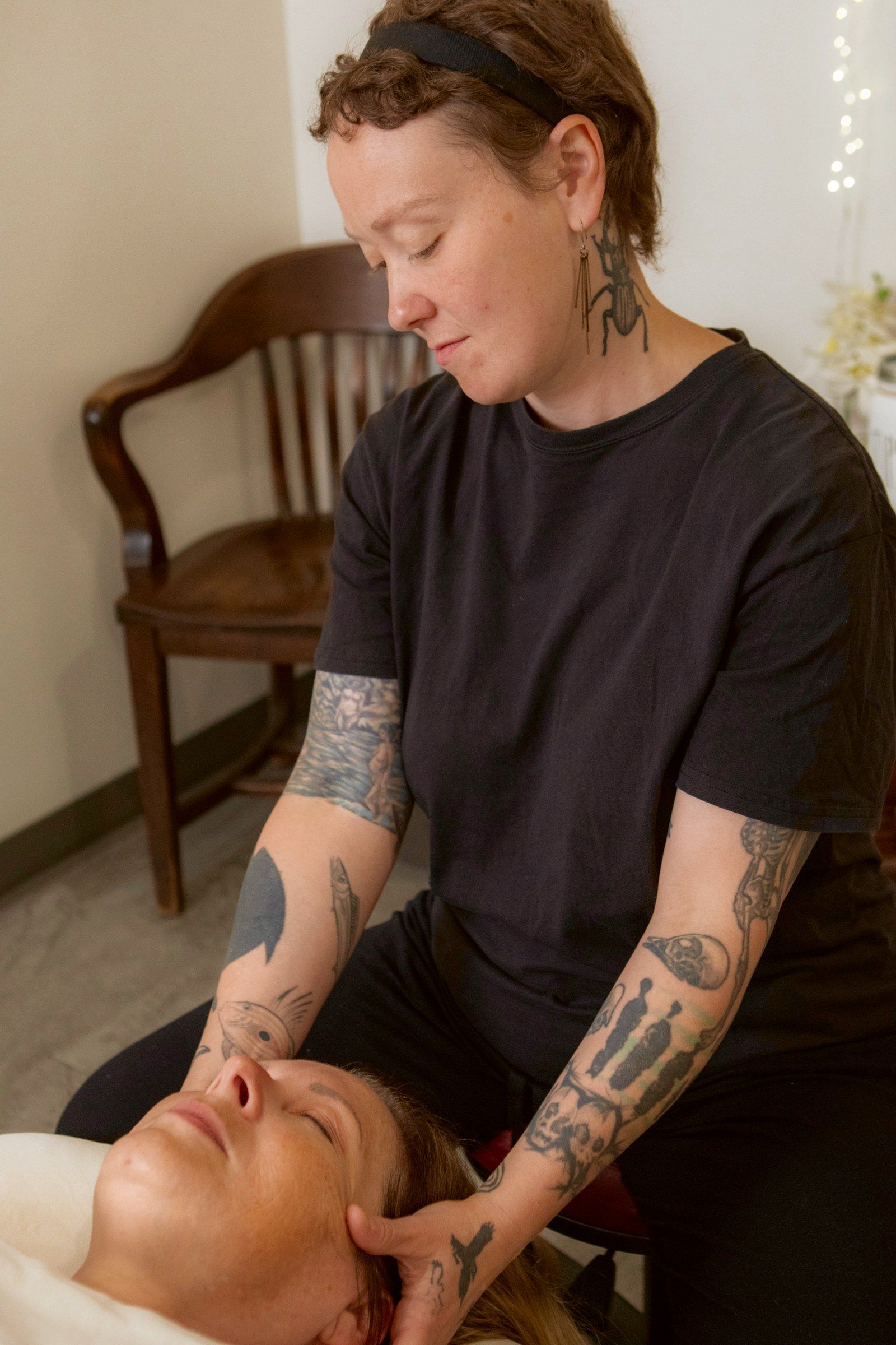 Nicole working a client's neck and head, face up