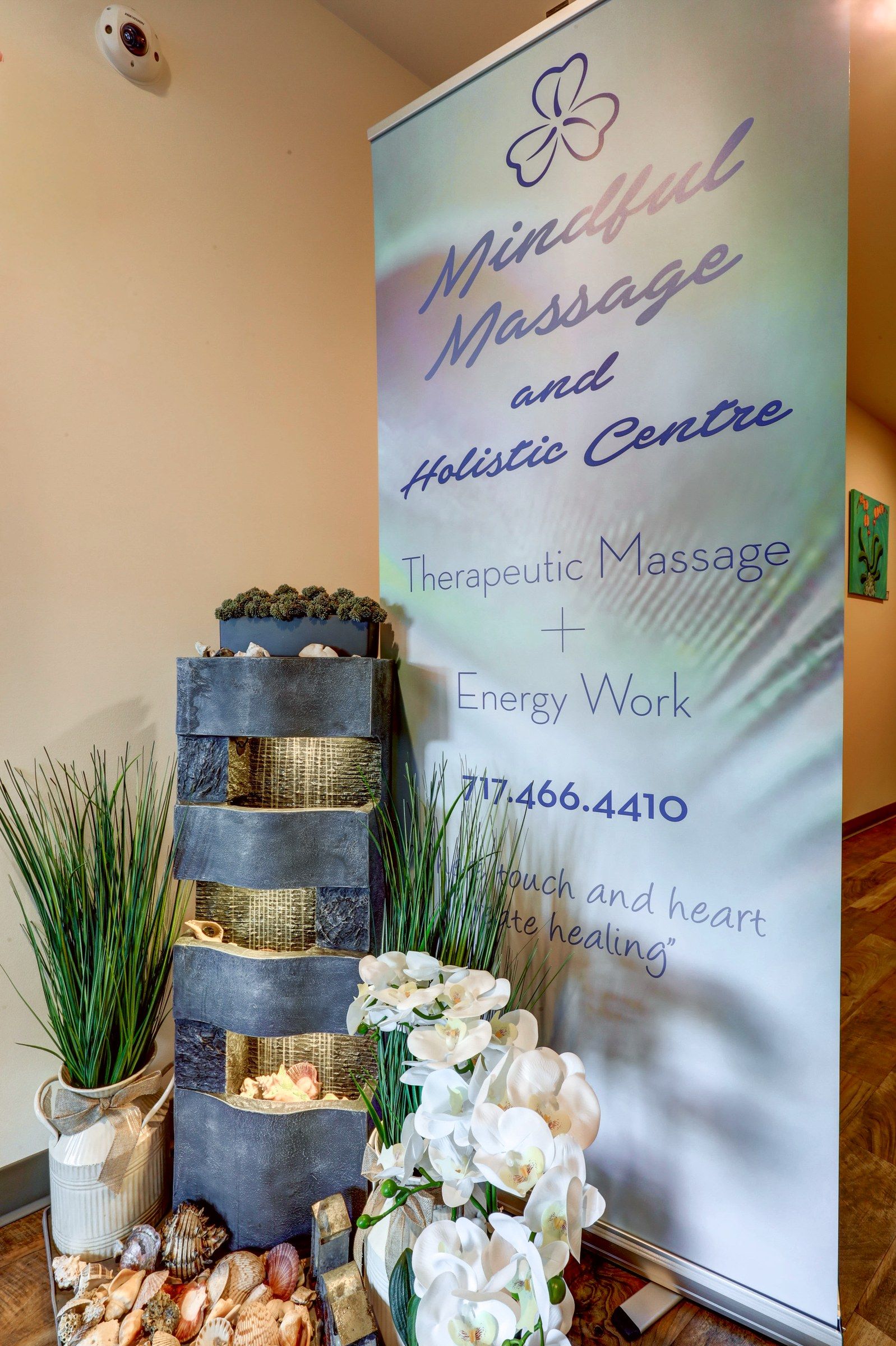 The entrance: the Mindful Massage banner beside a stone water fountain