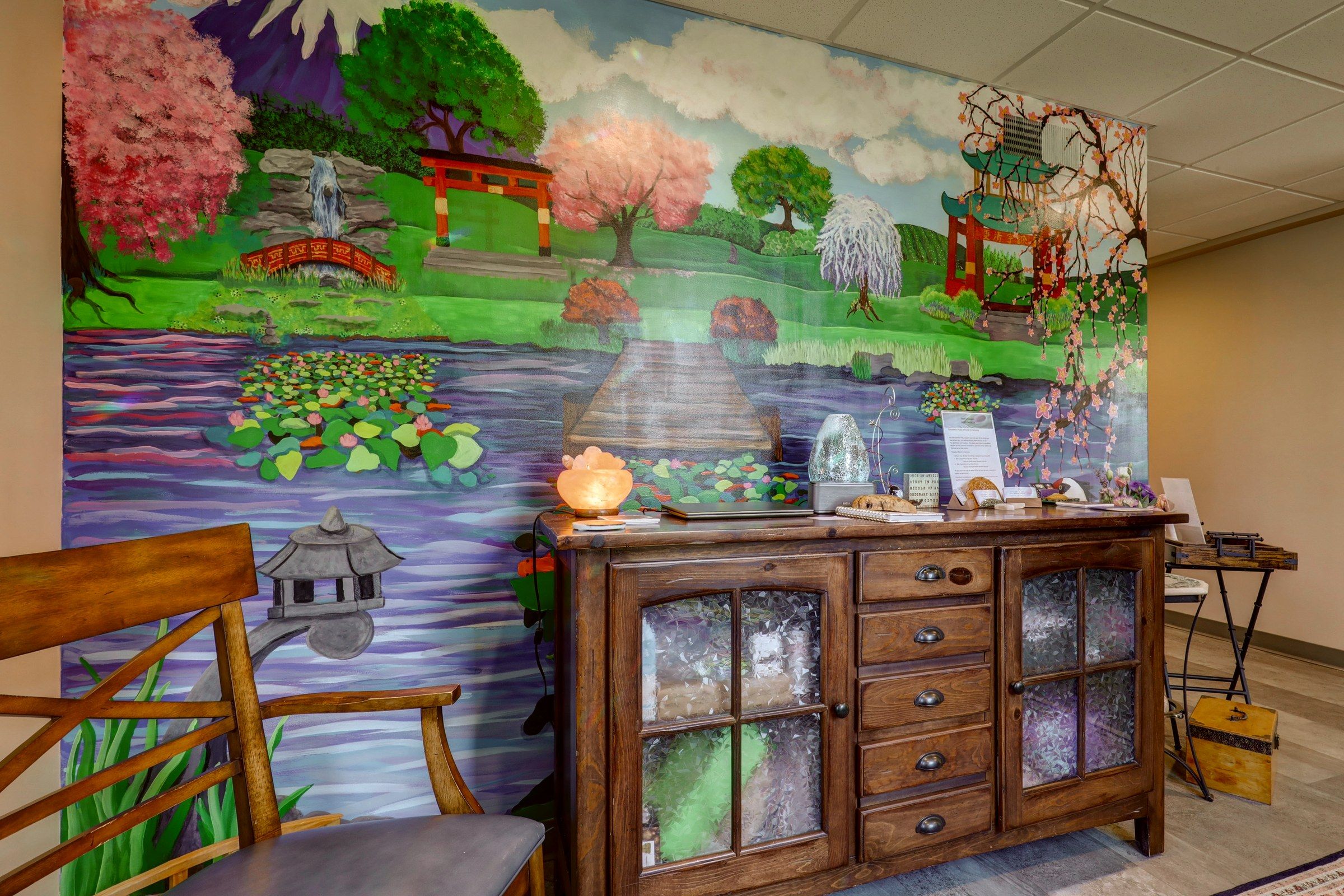 The mural: a pagoda, cherry blossom and a koi pond above an antique cabinet